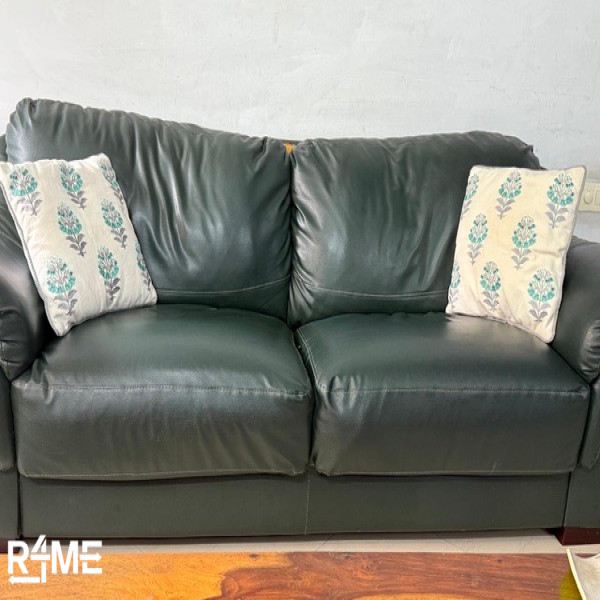 green color sofa single piece space for three on rent